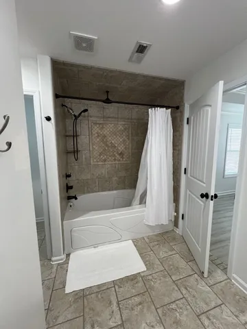 a bathroom with a bathtub and a shower
