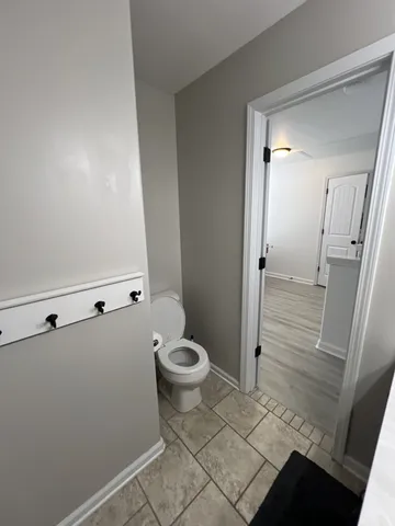 a bathroom with a toilet and a shower