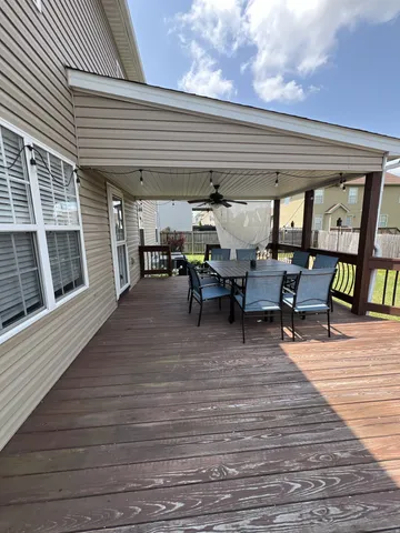 a view of a patio with table and chairs