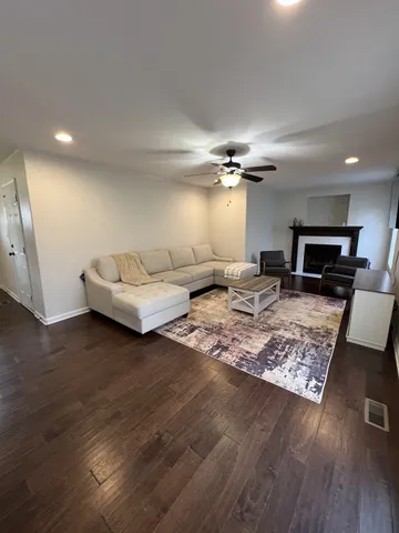 a living room with furniture and a wooden floor