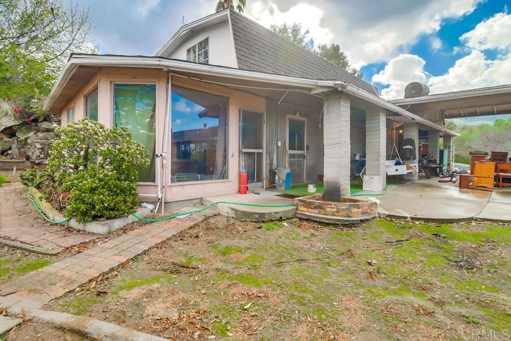 3063 Millar Ranch Road Spring Valley, CA 91978 - Photo 1 of 1 a view of a house with sitting area and garden