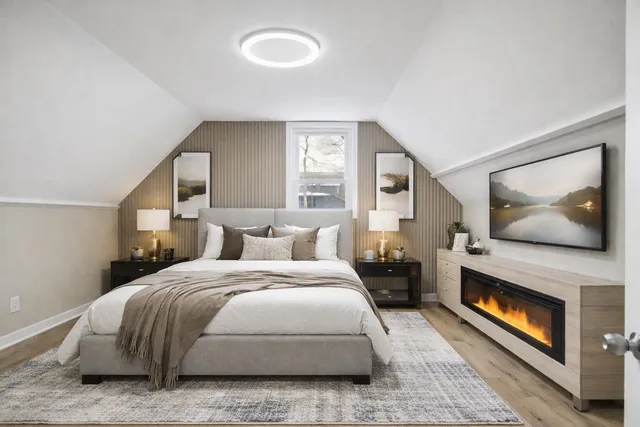 a bedroom with a bed and a painting on the wall