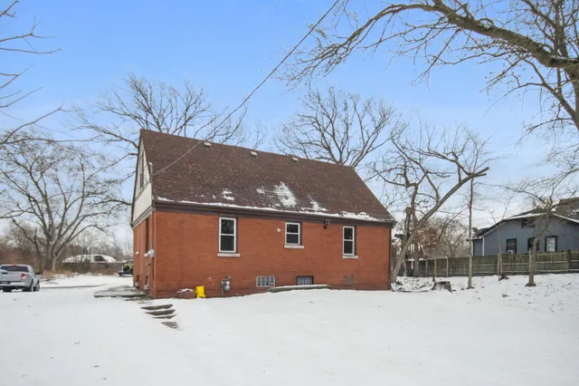 a view of a house with snow on the road