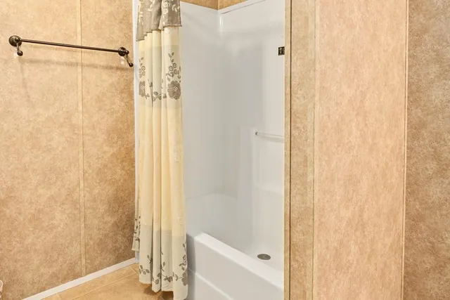 a bathroom that has a glass shower door