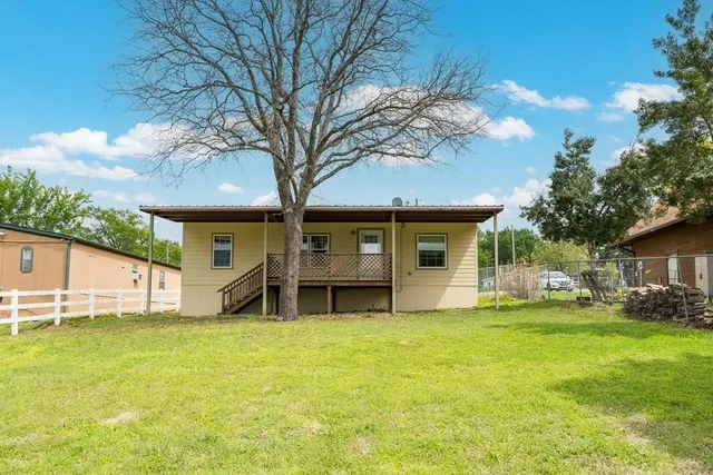 a green field with lots of trees