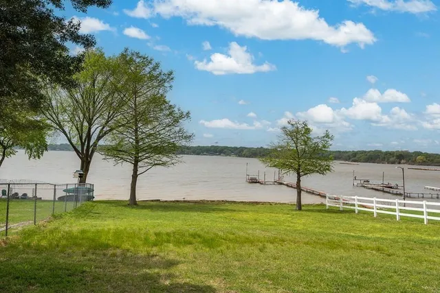 a living room with furniture a ceiling fan and a window