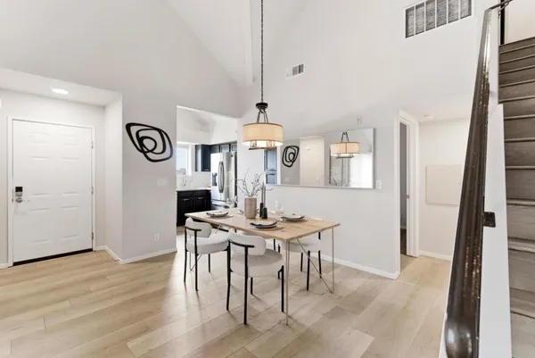 a view of a room with furniture and wooden floor