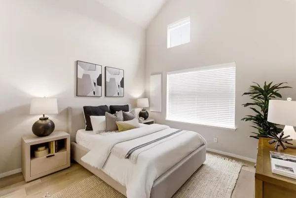 a bedroom with a bed and a window