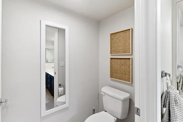 a white toilet sitting next to a bathroom sink