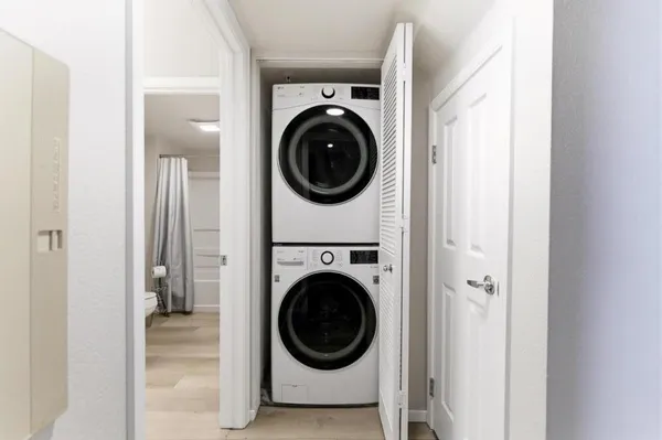 a view of a hallway with washer and dryer
