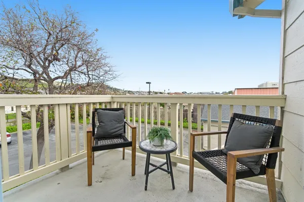 a view of a balcony with chairs