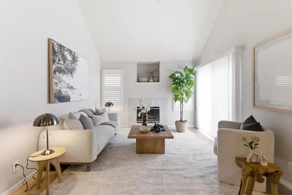 a living room with furniture and a fireplace