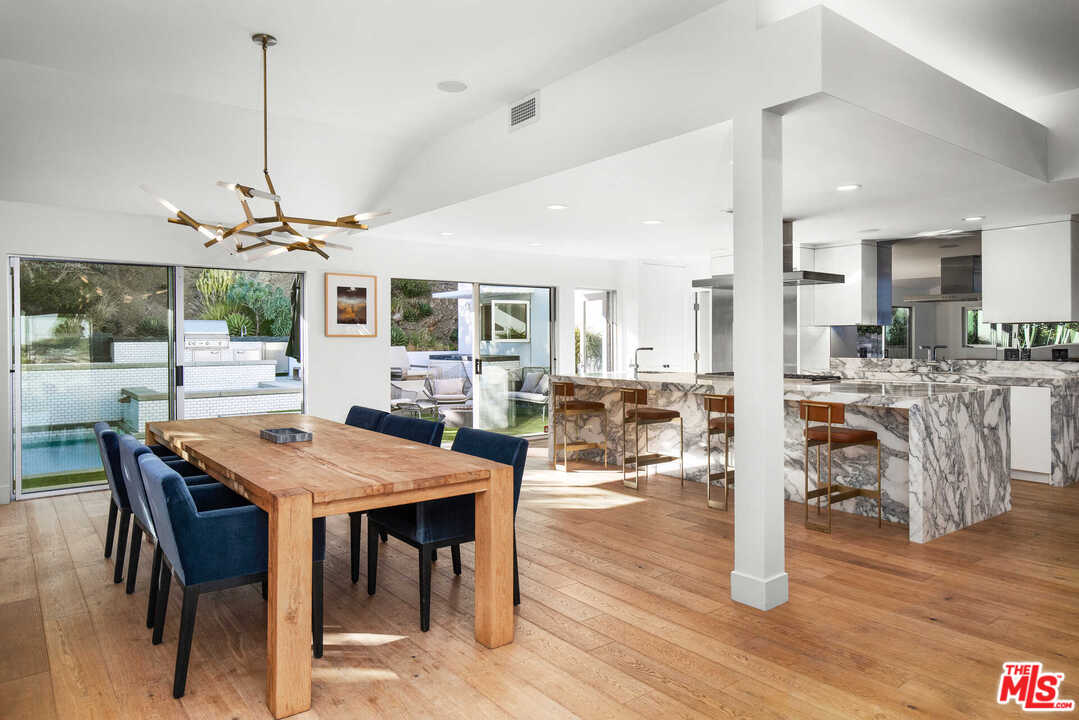 1239 Las Pulgas Road Pacific Palisades, CA 90272 - Photo 11 of 54 a view of a dining room with furniture window and wooden floor