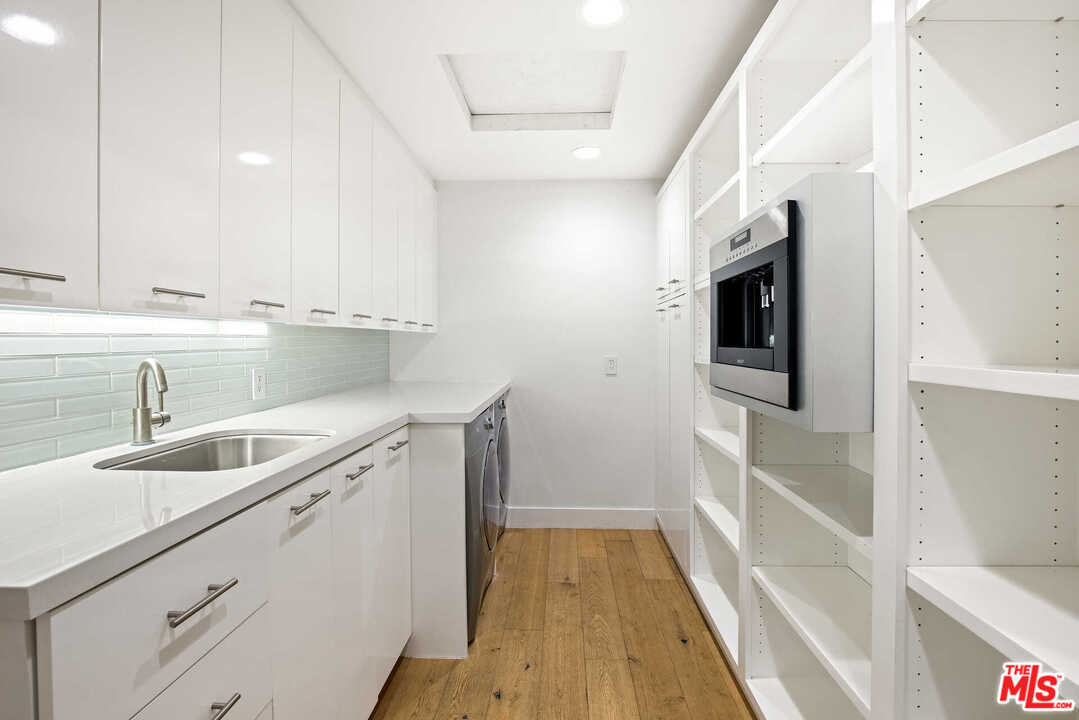 1239 Las Pulgas Road Pacific Palisades, CA 90272 - Photo 13 of 54 a kitchen with a sink and a microwave