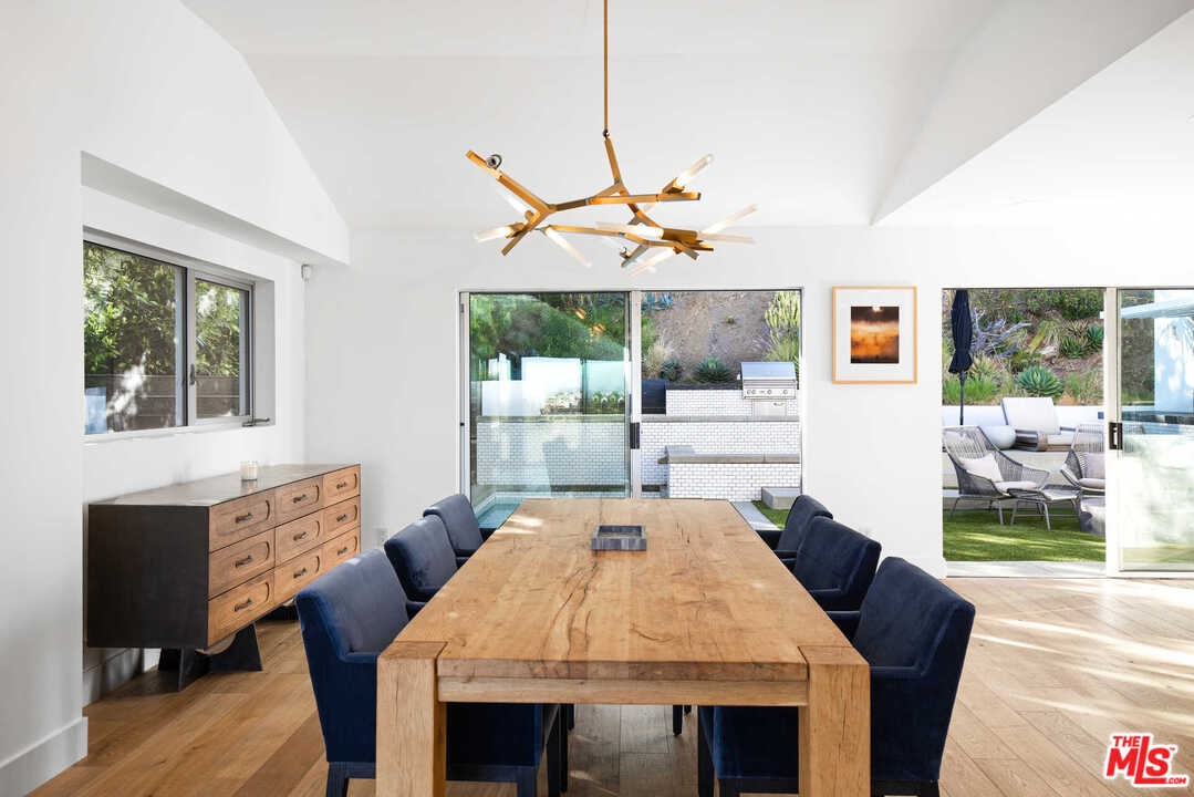 1239 Las Pulgas Road Pacific Palisades, CA 90272 - Photo 14 of 54 a dining room with furniture and window