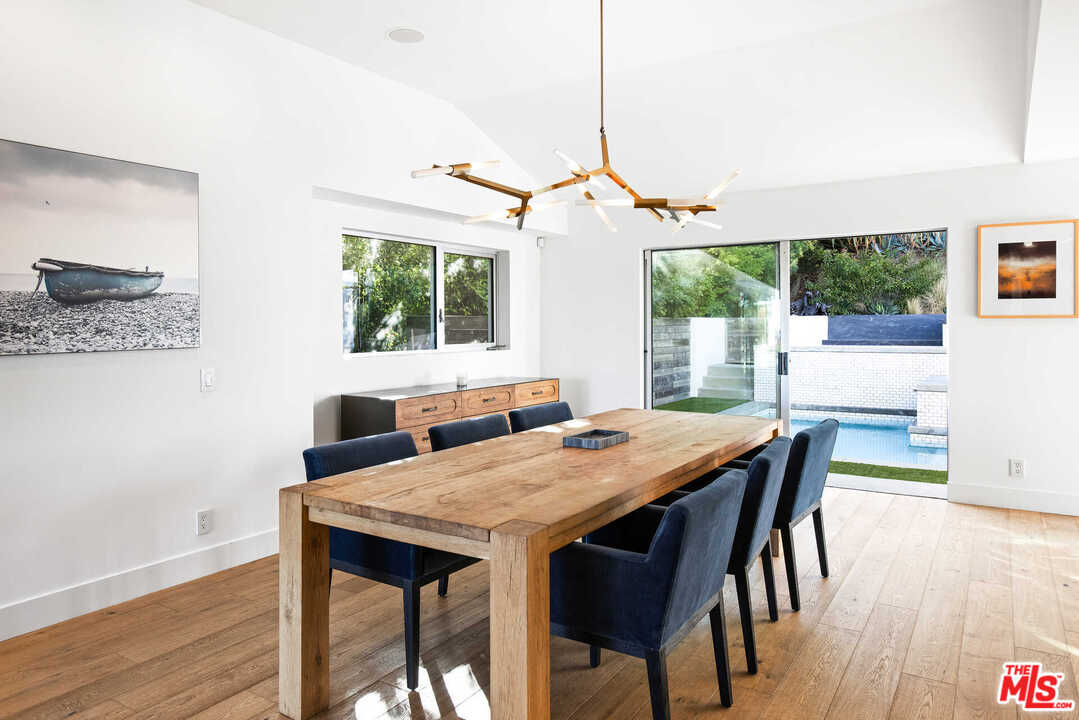 1239 Las Pulgas Road Pacific Palisades, CA 90272 - Photo 15 of 54 a view of a dining room with furniture window and wooden floor