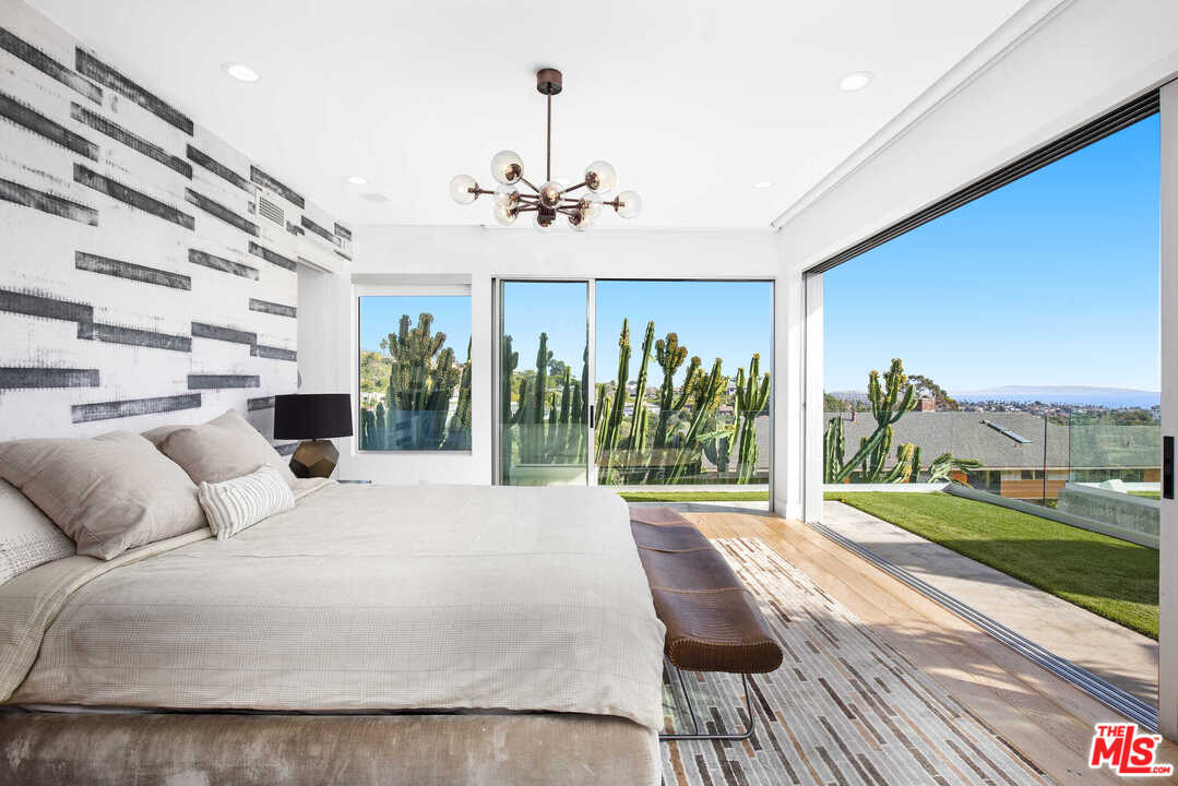1239 Las Pulgas Road Pacific Palisades, CA 90272 - Photo 22 of 54 a bedroom with furniture and a large window