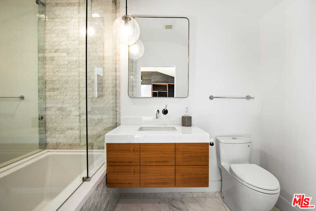 1239 Las Pulgas Road Pacific Palisades, CA 90272 - Photo 30 of 54 a bathroom with a sink a toilet and shower
