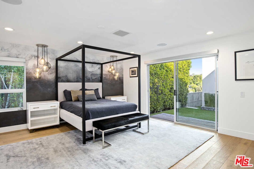1239 Las Pulgas Road Pacific Palisades, CA 90272 - Photo 31 of 54 a bedroom with furniture and a large window