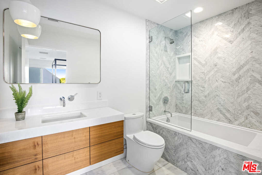 1239 Las Pulgas Road Pacific Palisades, CA 90272 - Photo 33 of 54 a bathroom with a sink a toilet and shower
