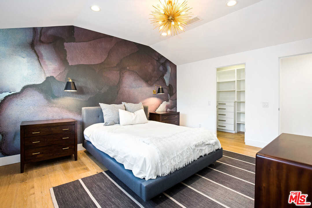 1239 Las Pulgas Road Pacific Palisades, CA 90272 - Photo 35 of 54 a bedroom with a bed and a lamp