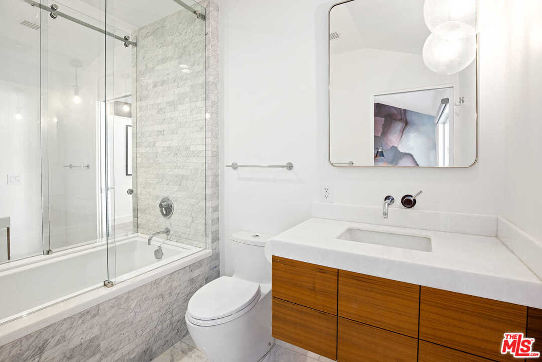 1239 Las Pulgas Road Pacific Palisades, CA 90272 - Photo 36 of 54 a bathroom with a sink toilet vanity and shower