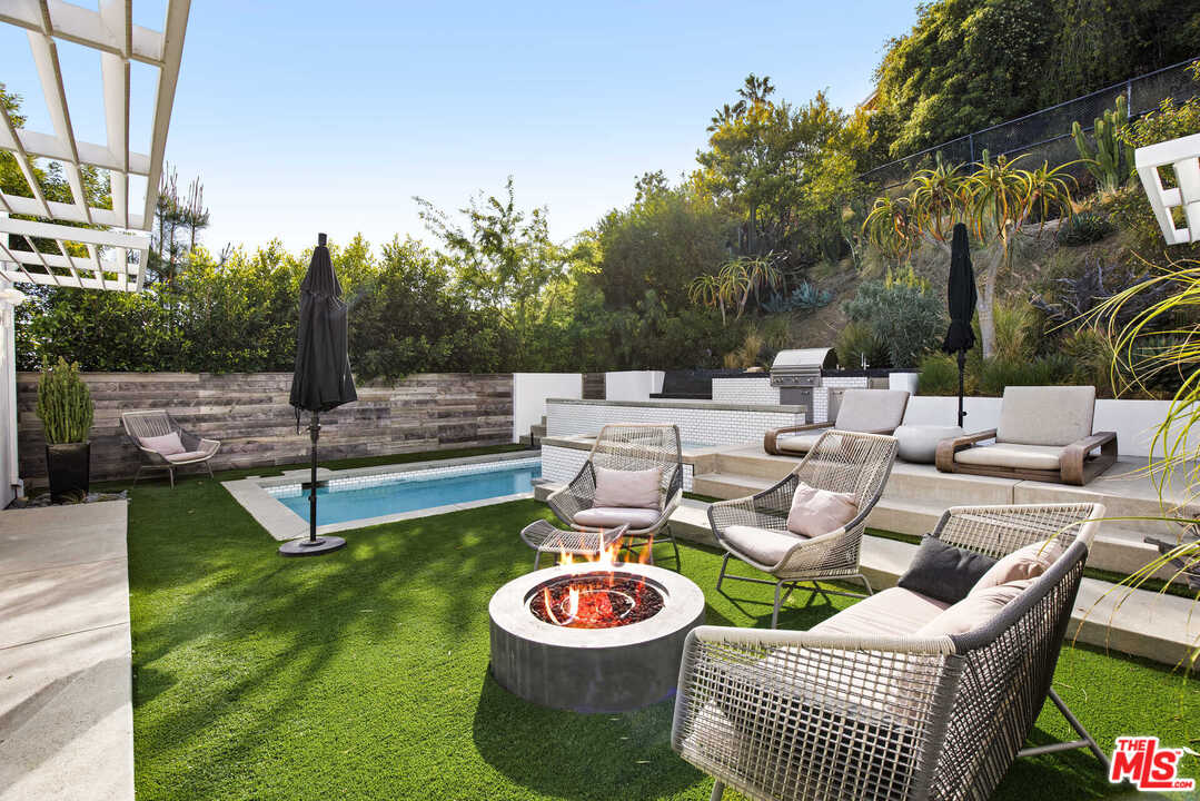 1239 Las Pulgas Road Pacific Palisades, CA 90272 - Photo 37 of 54 a patio with patio a table and chairs