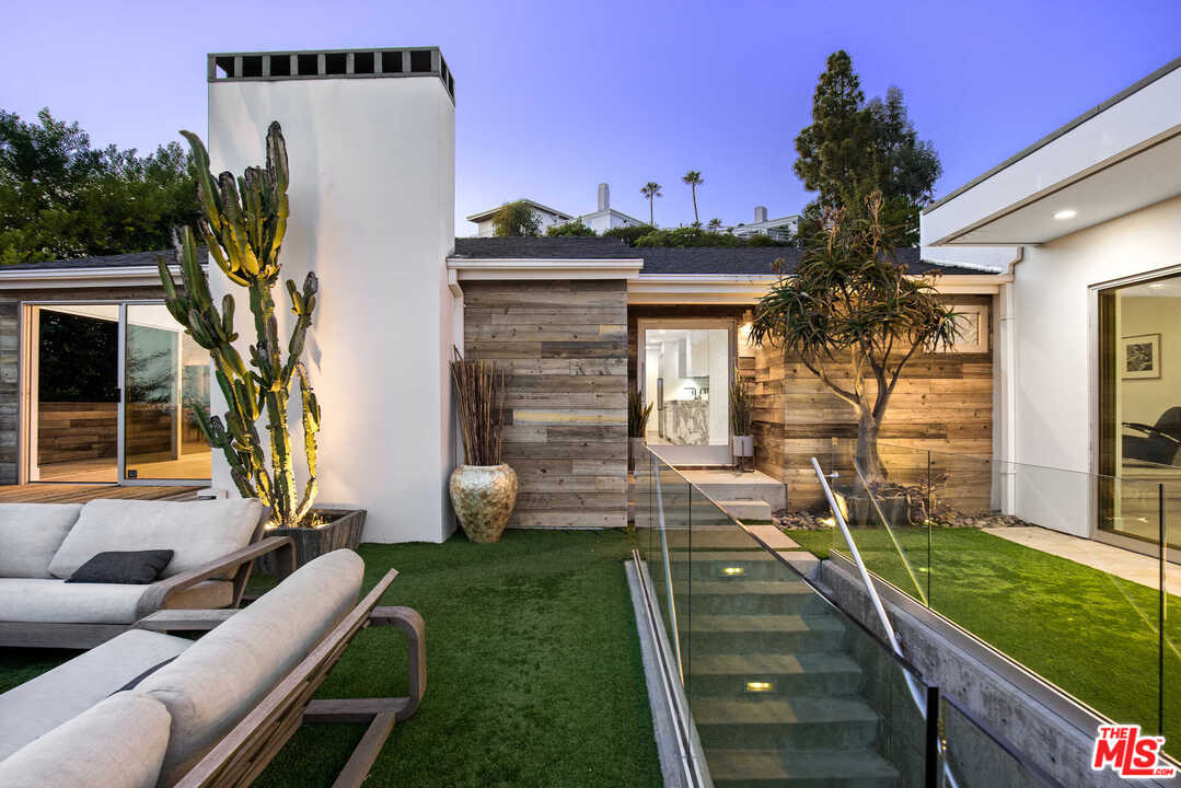1239 Las Pulgas Road Pacific Palisades, CA 90272 - Photo 47 of 54 a view of a house with backyard and a tree