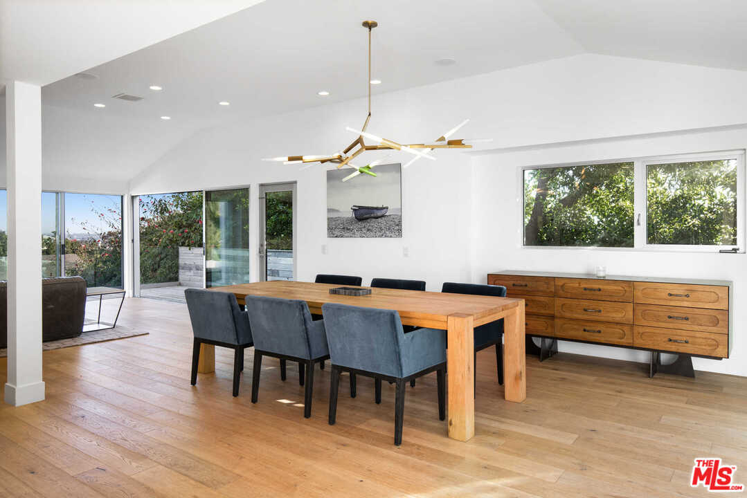 1239 Las Pulgas Road Pacific Palisades, CA 90272 - Photo 8 of 54 a view of a dining room with furniture window and wooden floor