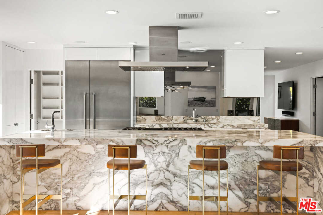 1239 Las Pulgas Road Pacific Palisades, CA 90272 - Photo 10 of 54 a large kitchen with kitchen island granite countertop a counter top stainless steel appliances and cabinets