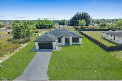 a aerial view of a house with swimming pool garden view and lake view