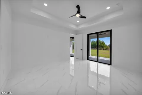 a view of a livingroom with a ceiling fan and window