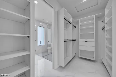 a bathroom with a shower and a glass door