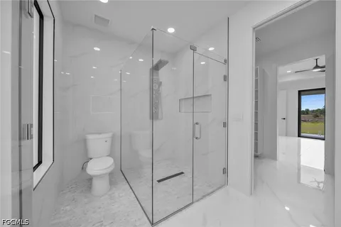 a bathroom with a shower a toilet and a sink