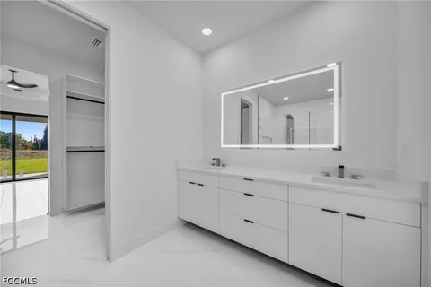 a bathroom with a double vanity sink and a mirror