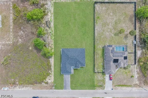 an aerial view of a house with a yard