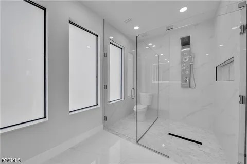 a bathroom with a shower and a glass door