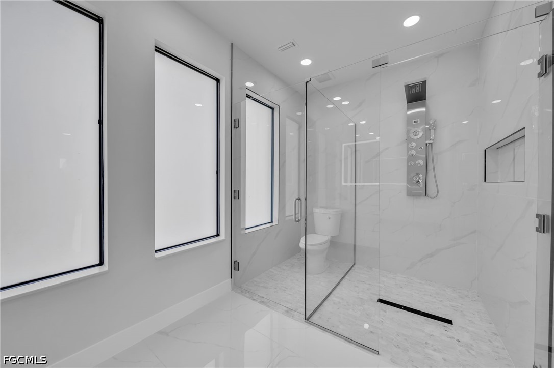 1618 Moore Avenue Lehigh Acres, FL 33972 - Photo 21 of 41 a bathroom with a shower and a glass door