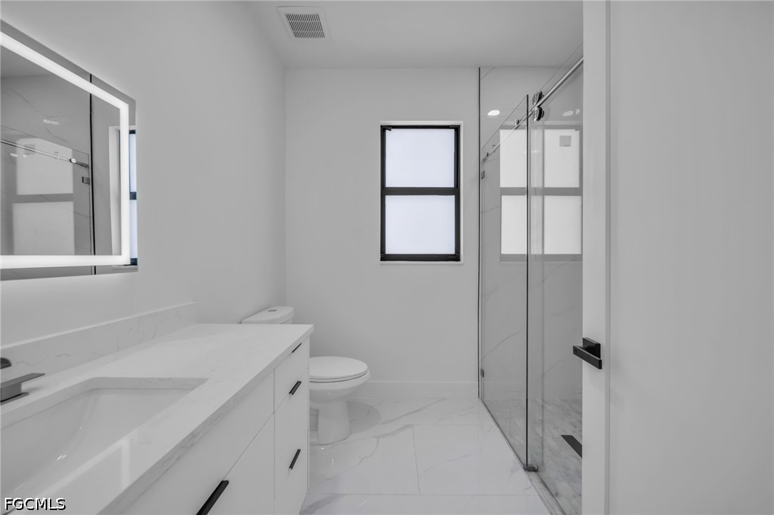 1618 Moore Avenue Lehigh Acres, FL 33972 - Photo 23 of 41 a bathroom with a sink toilet and shower