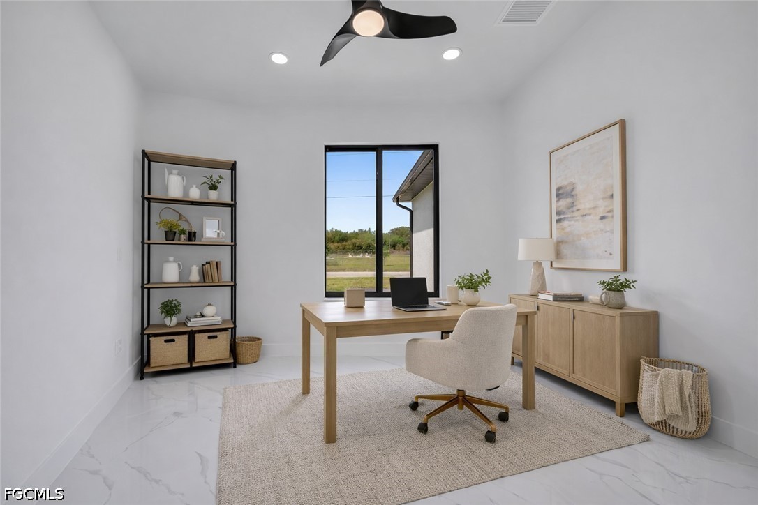1618 Moore Avenue Lehigh Acres, FL 33972 - Photo 27 of 41 a view of a workspace with furniture and a window