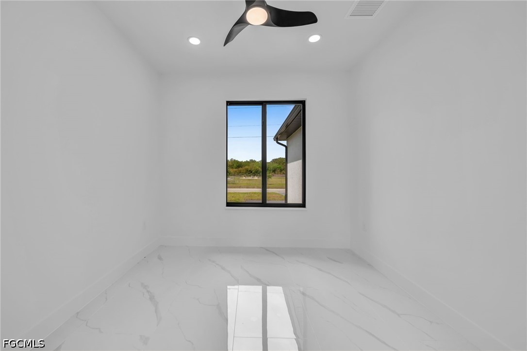 1618 Moore Avenue Lehigh Acres, FL 33972 - Photo 28 of 41 an empty room with windows and fan