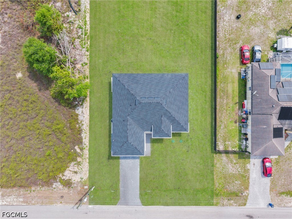 1618 Moore Avenue Lehigh Acres, FL 33972 - Photo 34 of 41 a bird view of house with yard