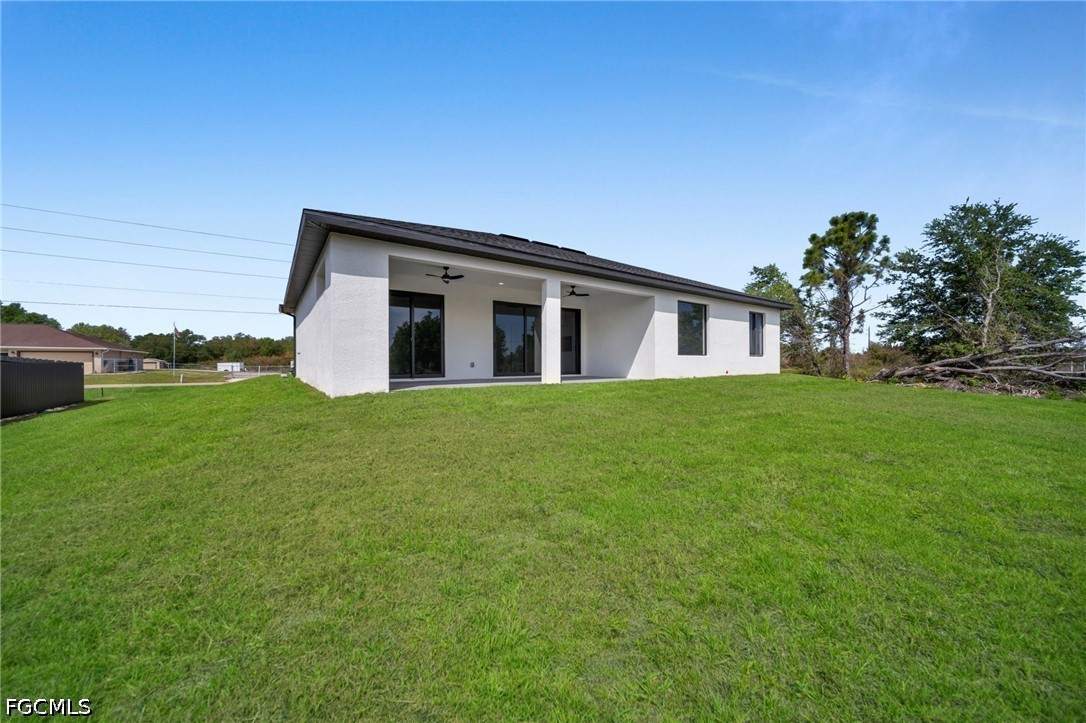 1618 Moore Avenue Lehigh Acres, FL 33972 - Photo 36 of 41 a view of house with backyard