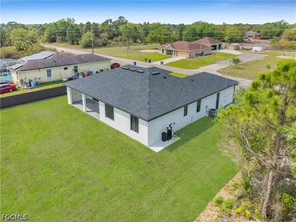 a aerial view of a house with swimming pool and ocean view