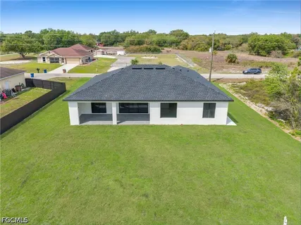 a aerial view of a house with a yard and lake view