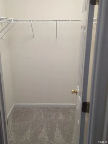 a view of a livingroom with wooden floor and staircase
