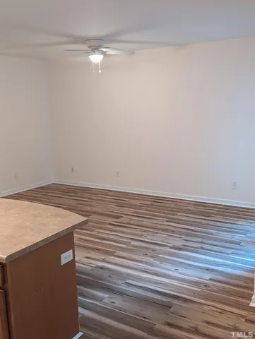 a view of a room with wooden floor and bench