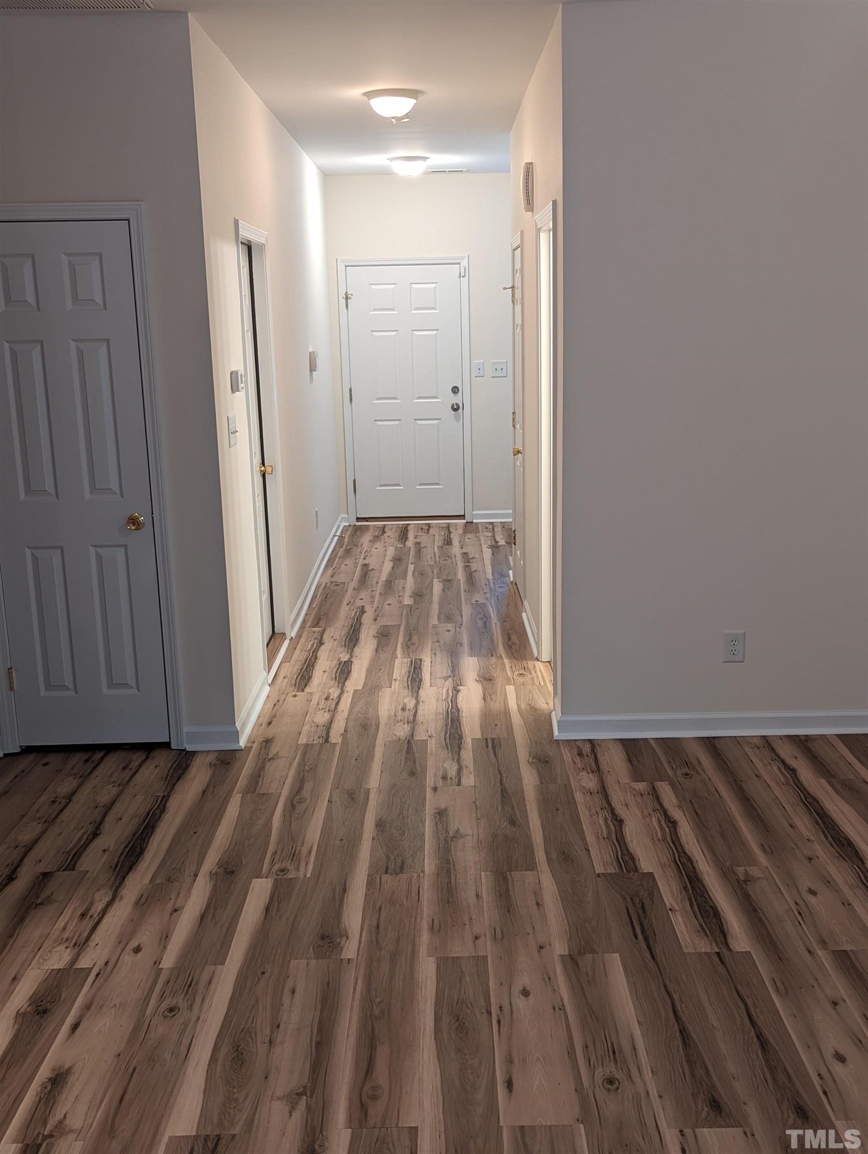 350 Plaza Drive, Unit D Chapel Hill, NC 27517 - Photo 7 of 13 a view of a room with wooden floor and bench