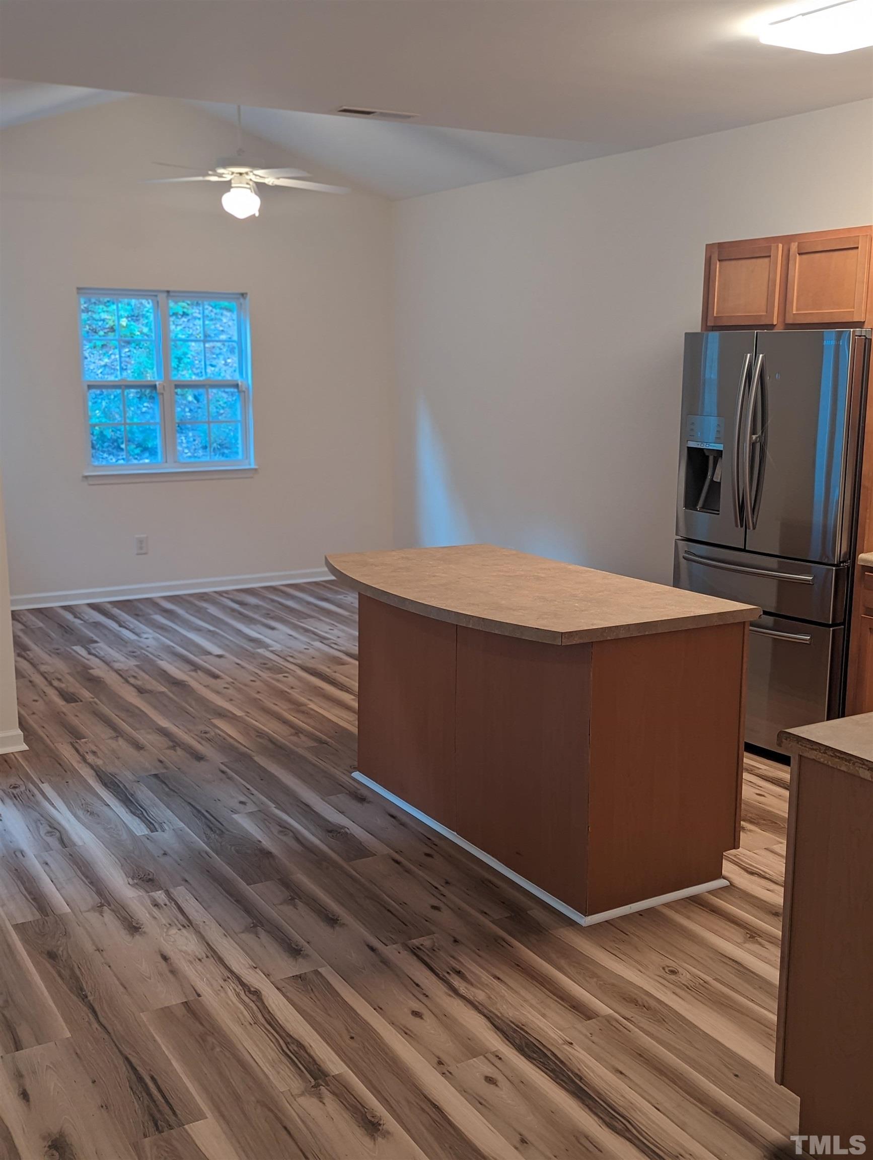 350 Plaza Drive, Unit D Chapel Hill, NC 27517 - Photo 9 of 13 a room with wooden floor and stainless steel appliances