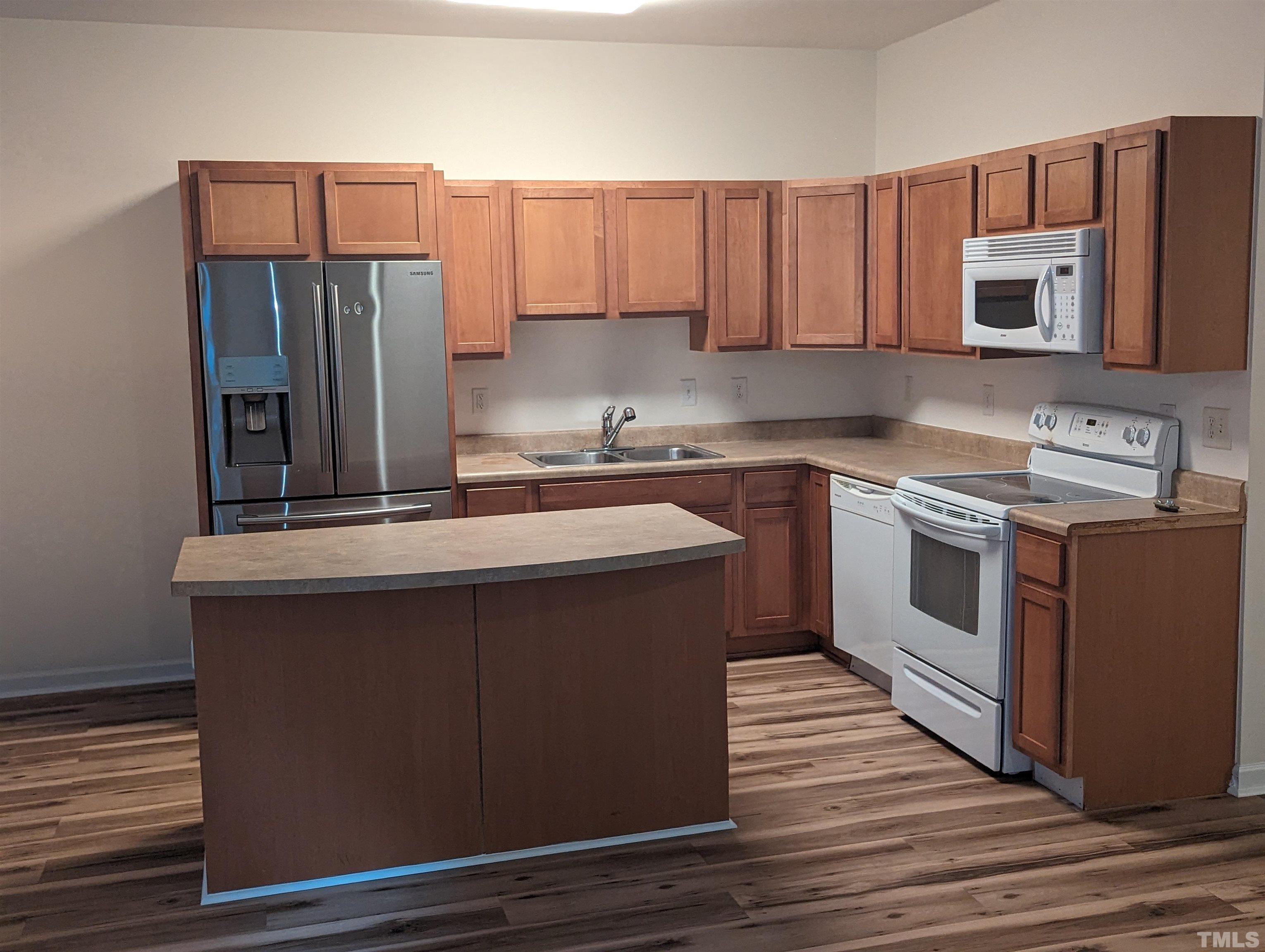 350 Plaza Drive, Unit D Chapel Hill, NC 27517 - Photo 10 of 13 a kitchen with stainless steel appliances a sink stove and refrigerator
